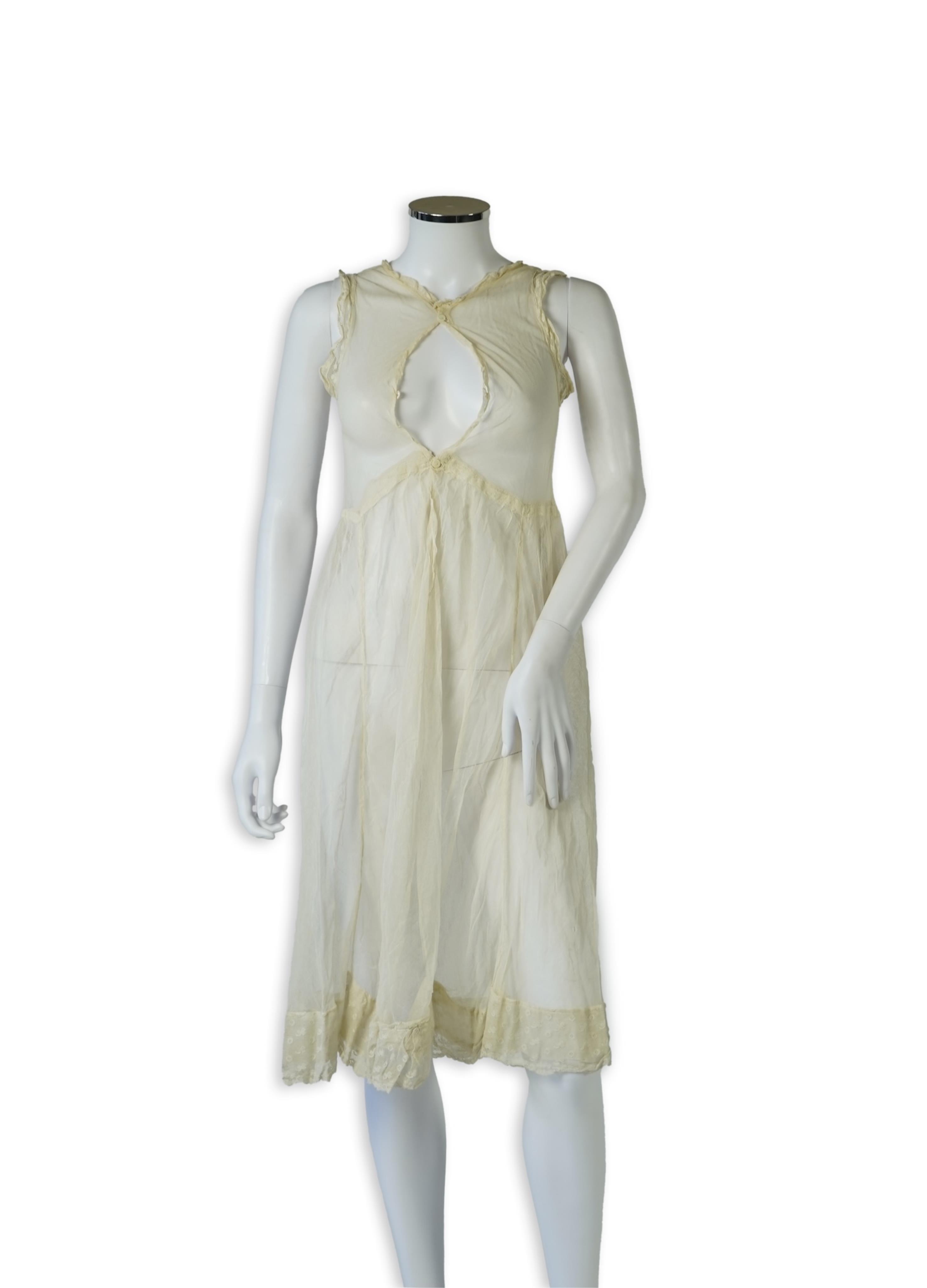 An early 20’s cream net ladies summer dress and net petticoat, designed with a lace inset front skirt, yolk and sleeves.103cm long. Condition - both need re-laundering and some seams tidying.